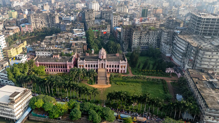 Fototapeta premium Aerial View of Mesmerizing Ahsan Manzil on the Bank of River Buriganga in Old Dhaka. Ahsan Manzil is located in Kumartoli along the banks of the Buriganga River in Dhaka, Bangladesh