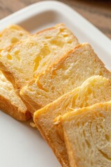 Golden Toasted Bread Slices on a White Plate, stock photo