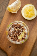 Nutritious Breakfast Bowl with Cereal and Fresh Pomelo on a Wooden Board, stock photo