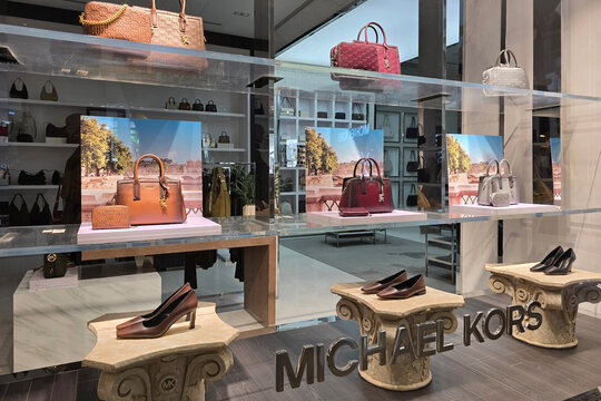 Penang, Malaysia &ndash; Oct 14, 2025: Exterior view of the Michael Kors luxury fashion boutique at the Paragon Mall, featuring illuminated signage and a stylish window display of handbags and accessories.