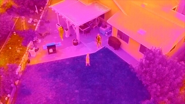 Training Video for Infrared inspection looking at a neighborhood and a house as seen from a a Drone with subjects swwn in Thermal Scans and a dog playing frisbee.