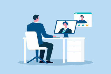 Man in suit having a video conference call with colleague on computer screen