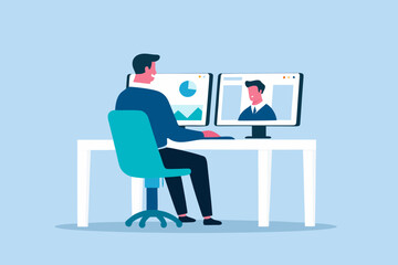 Man working at a desk with dual monitors showing charts and a video call with a colleague