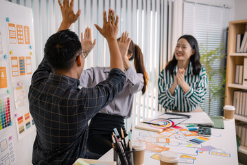 UX/UI designers collaborating during a creative workshop to test interface ideas and exchange feedback for app development, emphasizing teamwork and innovative design thinking.