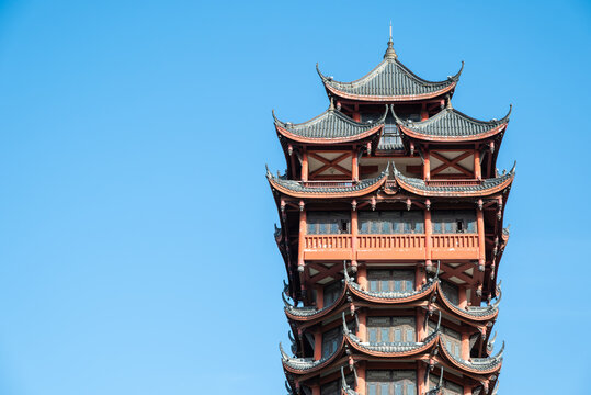 Elegant Red Chinese Pagoda Tower With Multi-Tier Roofs Under Bright Blue Sky