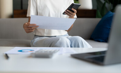 Asian Woman Managing Finances pay Bills and Budget financial at home.