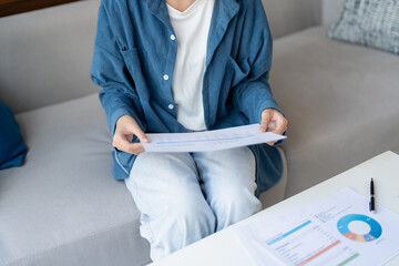 Asian Woman Managing Finances pay Bills and Budget financial at home.