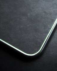 Neon rim corner charcoal texture glowing edge rounded corner minimal design dark surface modern detail abstract closeup metallic trim soft light. Neon rim corner charcoal texture with glowing edge