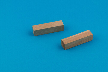 Wooden blocks arranged on a bright blue background for creative play