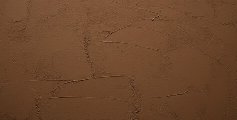 Brown textured wall surface with subtle variations in color and pattern, resembling rustic concrete with natural warmth and a handcrafted aesthetic for modern interiors.