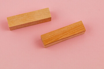 Wooden blocks on a pink background for creative crafting projects
