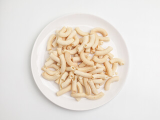 Crunchy macaroni snacks, piled on white background