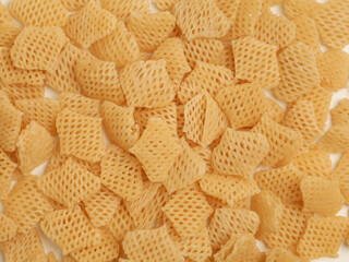 Raw crackers, piled on white background
