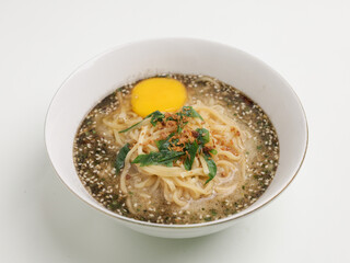 Noodle cooked in meat broth served with raw egg