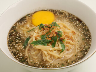 Noodle cooked in meat broth served with raw egg