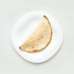 Half empanada on white plate - tasty pastry food presentation with crispy texture.