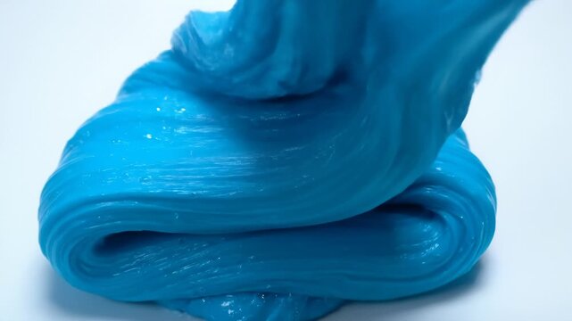 Stretching and Compressing Bright Blue Slime Against White Background, Close Up
