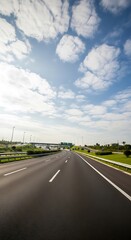 Fototapeta premium The picture shows a beautiful natural landscape with green hills and a clear blue sky. In the middle of the field, a group of deer is grazing peacefully. Tall trees surround the area, and a small rive