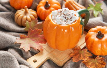 Cozy pumpkin mug with hot chocolate and marshmallows