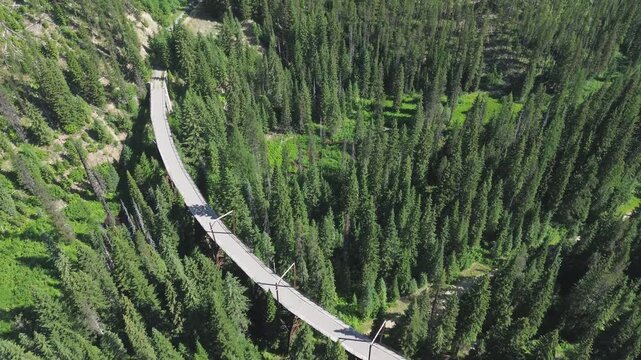 Dominion Creek trestle, now Rails to Trails, in Washington. High angle flyover shot that slowly rotates shows the trestle with  4 catenary (overhead electrical) towers on the trestle.