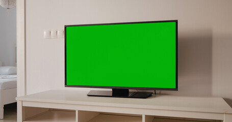 Chroma key smart TV in living room closeup. Device with blank screen and copy space.