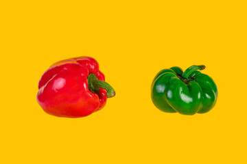 Red,yellow and green sweet peppers on yellow background