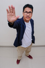 Closeup shot of man raising his palm to stop an action