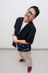 Man standing with both hands pressing his stomach suffering from stomachache