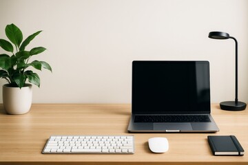 Fototapeta premium Minimal workspace mockup with laptop, keyboard, mouse, lamp, plant, and notebook on wooden desk in bright interior with empty background wall.