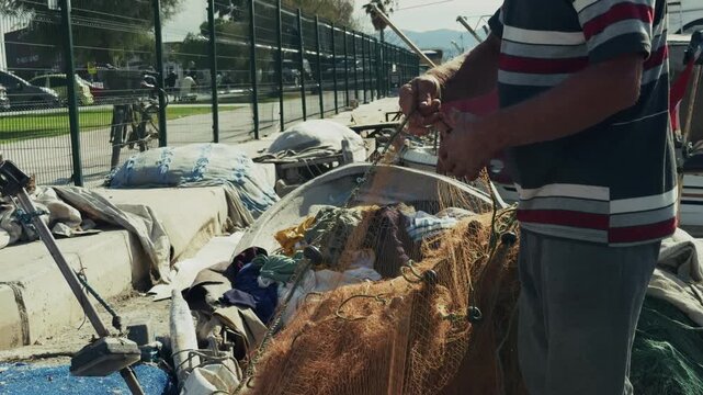 Fisherman is Repairing Fishnets Fishing Lines