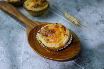 Homemade mini tarts placed on a rustic wooden board with a warm natural background. Perfect for food blogs, bakery advertisements, or recipe illustrations
