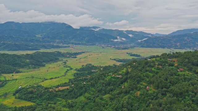 Aerial view of lush green paddy fields in Tansen Palpa, Nepal, surrounded by beautiful mountains and rural landscapes, showcasing the region&rsquo;s rich agriculture and natural beauty.