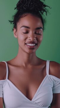 female influencer only wearing white top with a solid green background