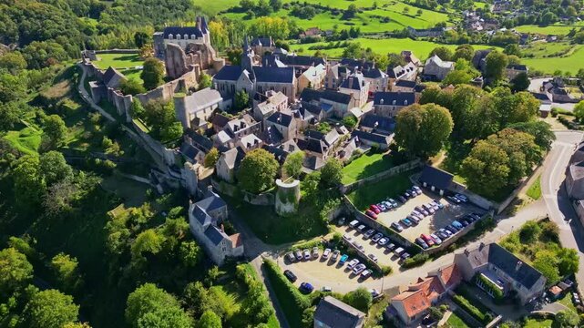 Sainte-Suzanne medieval city, castle, church, Mayenne, France. Aerial drone forward