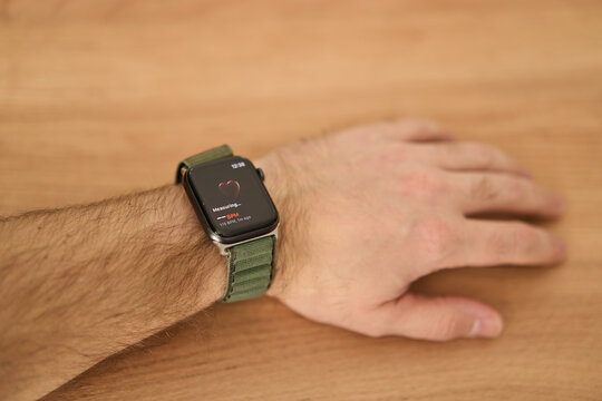 A square smartwatch on a man's hand close up. Heart rate measurement on watch. High quality photo