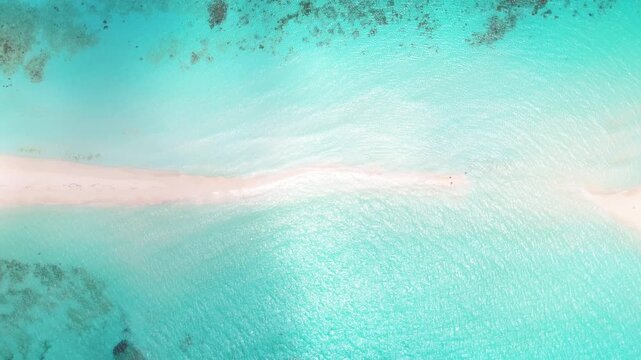 Top down aerial view of sandbar of Cayo de Agua, Los Roques, Venezuela, turquoise beach merging with shallow sea.