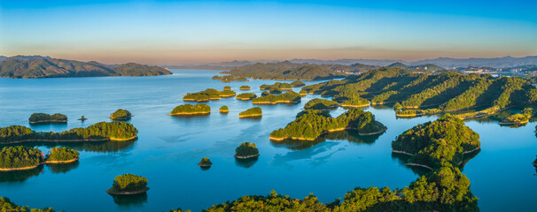 Aerial view of the beautiful lake and green mountain natural landscape at sunrise. Famous Qiandao Lake scenery in Hangzhou, China.