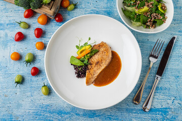 Grilled chicken fillet with black rice and vegetables in sauce