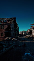 Fototapeta premium In a desolate setting, crumbling buildings stand silent beneath a clear blue sky, showcasing the remnants of a lost community. Debris litters the ground, hinting at former life.