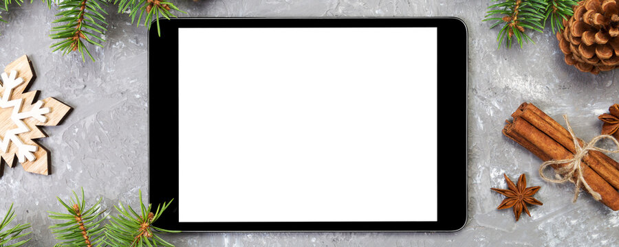 Digital tablet mock up with rustic Christmas gray cement background decorations for app presentation. top view with copy space