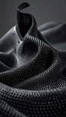 Woven, textured, curled, dark textile in monochrome