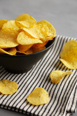 Sour Cream and Onion Flavored Chips in a Bowl, side view. Close-up.