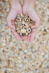 Hands holding gravel outdoor environment natural material focused viewpoint earthy concept for sustainable landscaping