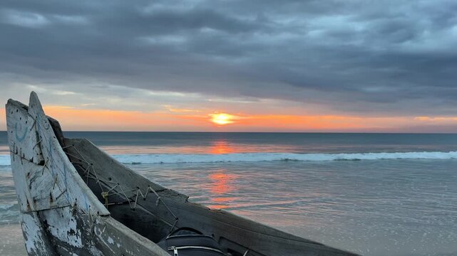 Boat on beach during sunset
