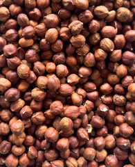 A pile of nuts with a lot of them being hazelnuts