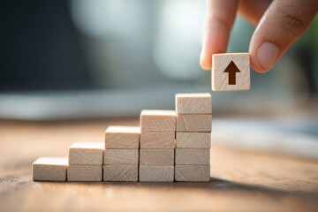 Close-up of a hand stacking wooden blocks into a staircase, symbolizing growth, progress, and career development.