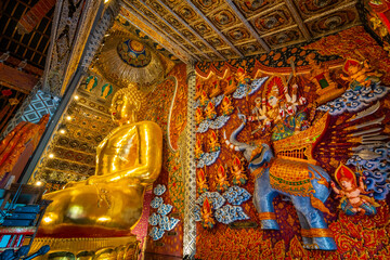 The golden Buddha statue at Wat Si Don Mun in Chiang Mai, Thailand, glows with divine beauty and rich Lanna art, creating a peaceful and spiritual atmosphere inside the temple.