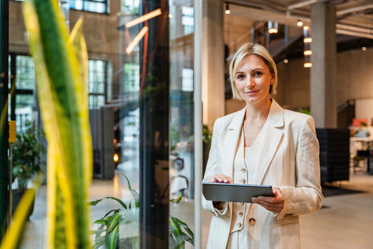 Portrait of businesswoman using tablet in modern office environment