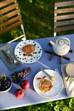 Apple puff pastry and tea on outdoor table in Altes Land garden