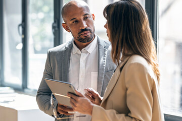 Business team having financial discussion in office with tablet